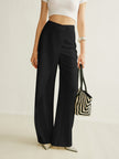 FJØRNA lightweight summer women's trousers with high waist, wide leg, and asymmetrical wrap design.