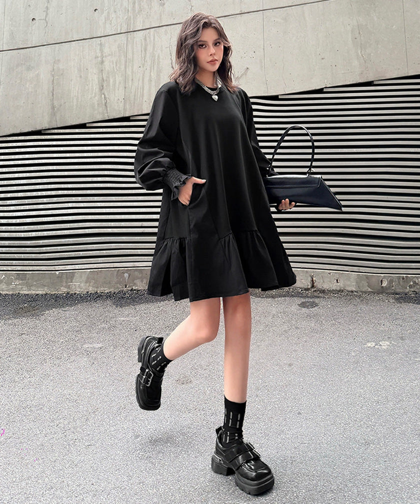 White FJØRNA volume flare dress with ruffled sleeves and a fitted waist, showcased on a mannequin.