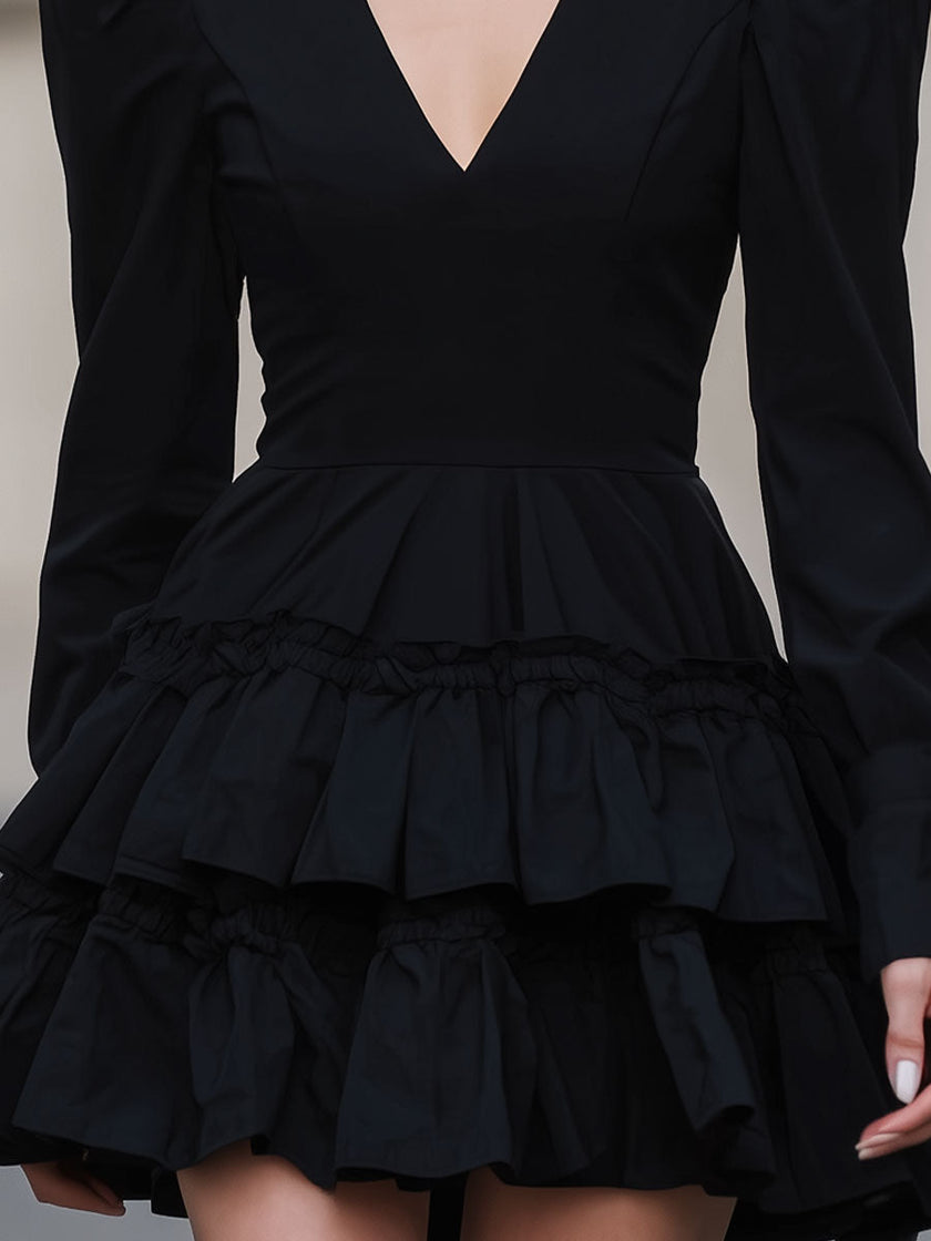 FJØRNA black leather mini dress with puff sleeves and tiered design, showcasing a stylish and dramatic mini dress silhouette.