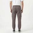 Men's slim fit cotton cargo trousers by FJØRNA, featuring multiple pockets and a modern fit, shown in a neutral color.