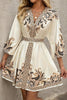 FJØRNA Champagne mini dress with printed V-neck, lantern sleeves, and waist tie, styled for a chic, elegant look.