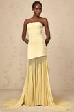 FJØRNA Josiane yellow off-shoulder sheer tulle maxi dress displayed on a model, featuring flowing fabric and elegant off-shoulder design.