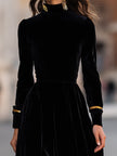FJØRNA elegant velvet midi dress with gold trim, showcasing a fitted design and luxurious fabric for sophisticated style.