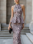 FJØRNA halter peplum midi dress with sculpted waist, featuring a fitted bodice and flowing skirt for women.