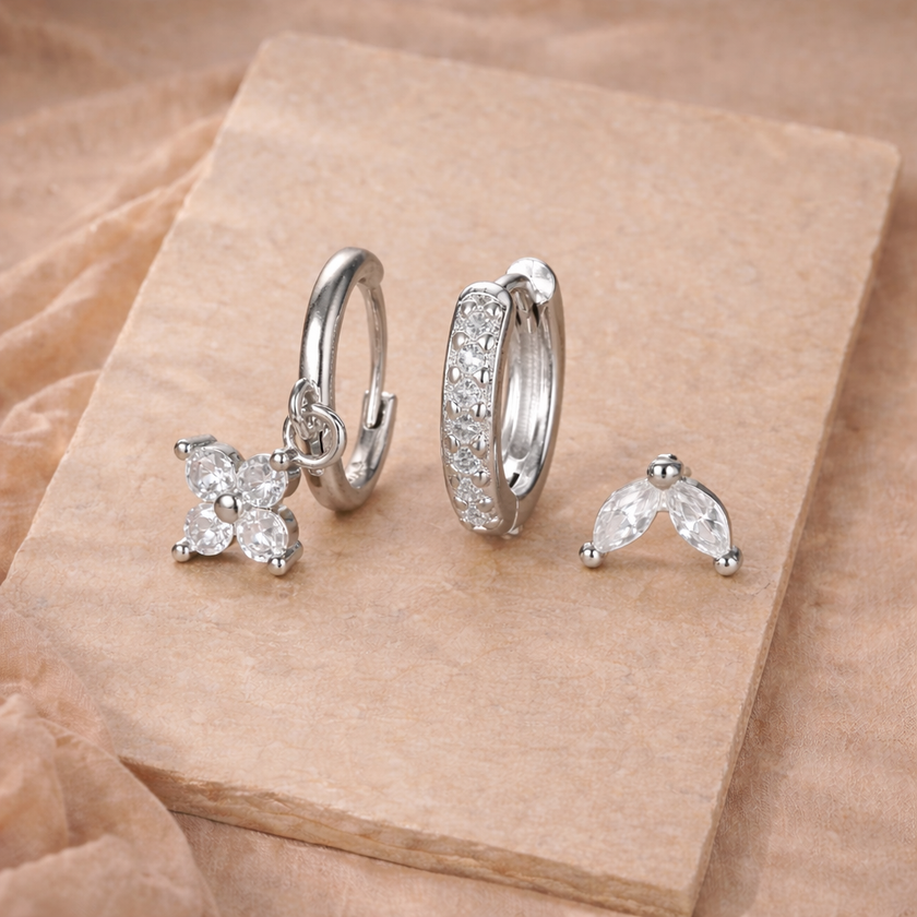 FJØRNA unisex piercing set accessories for women, featuring multiple metal earrings and nose studs in a variety of styles.