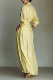 FJØRNA solid color lapel long sleeve maxi dress with casual pocket details and waist-cinching design displayed in the image.