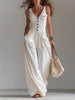 White sleeveless FJØRNA wide-leg jumpsuit with patch pockets, flowing fabric and a relaxed fit.