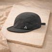Men's FJØRNA hat featuring a classic cap design with a curved brim and adjustable strap, made from durable fabric.