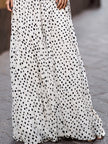 Elegant FJØRNA polka dot halter maxi dress with black lace waist inlay, flowing fabric and stylish design perfect for special occasions.
