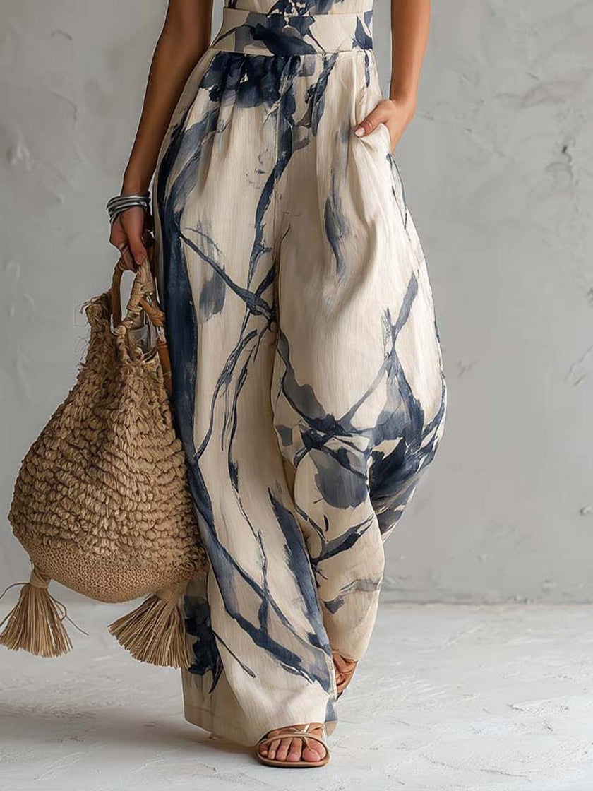 White ink wash print sleeveless jumpsuit with halter neck and wide-leg design featuring side pockets by FJØRNA.