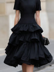 FJØRNA high neck tiered ruffle midi dress with layered fabric and elegant design, perfect for stylish occasions.