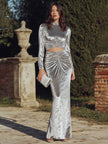 FJØRNA long sleeve ruched cutout evening gown with a fitted maxi dress design and elegant sleeves for formal occasions.