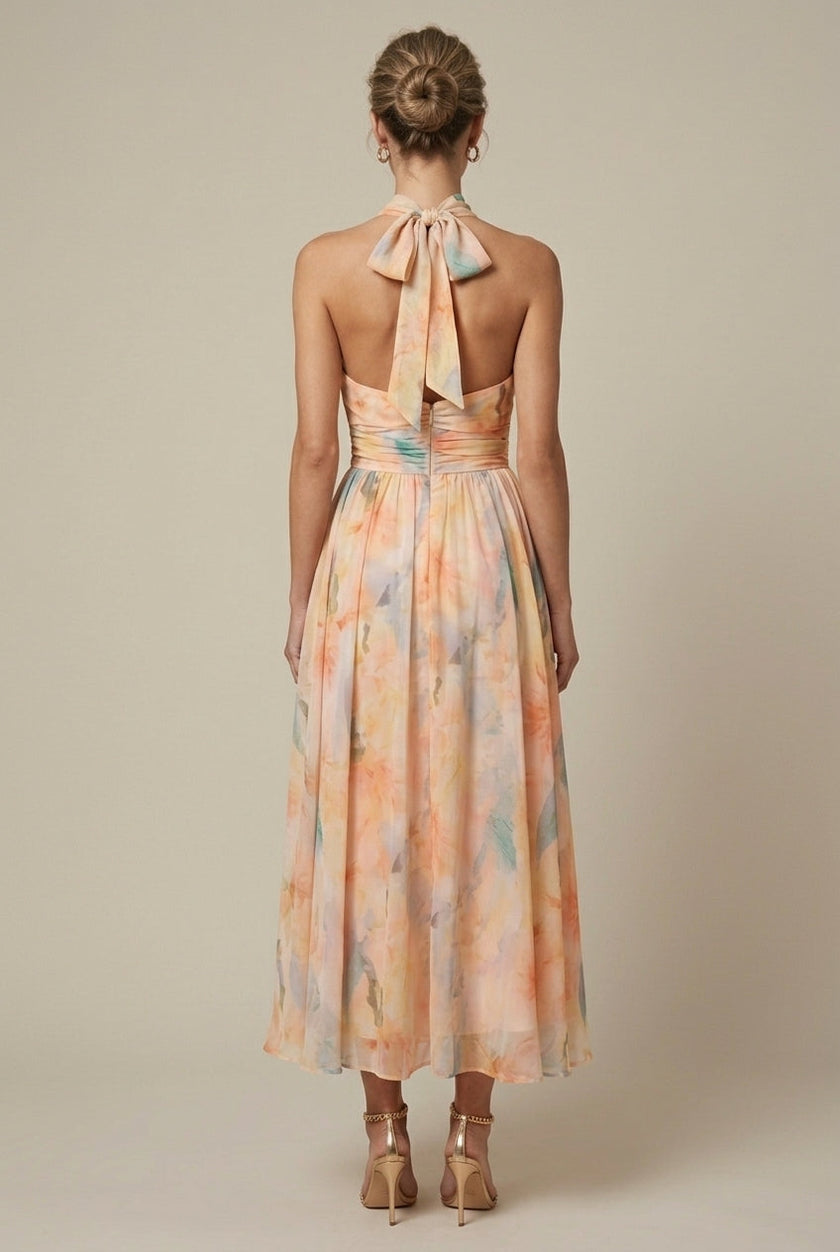 FJØRNA women's floral halter neck maxi dress with tie back, back view showing flowing fabric and floral pattern for wedding guest attire.