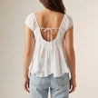 FJØRNA women's summer blouse with V-neck and short sleeves, shown from the back, lightweight and stylish for warm weather.