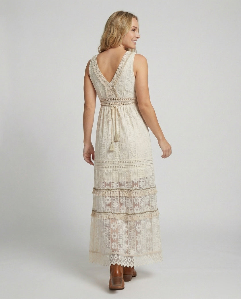 FJØRNA bohemian lace maxi dress with tiered skirt and tassel waist, back view showcasing intricate lace details and flowing design.