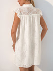 White lace casual wedding dress by FJØRNA, back view of a short, elegant summer dress perfect for romantic occasions.