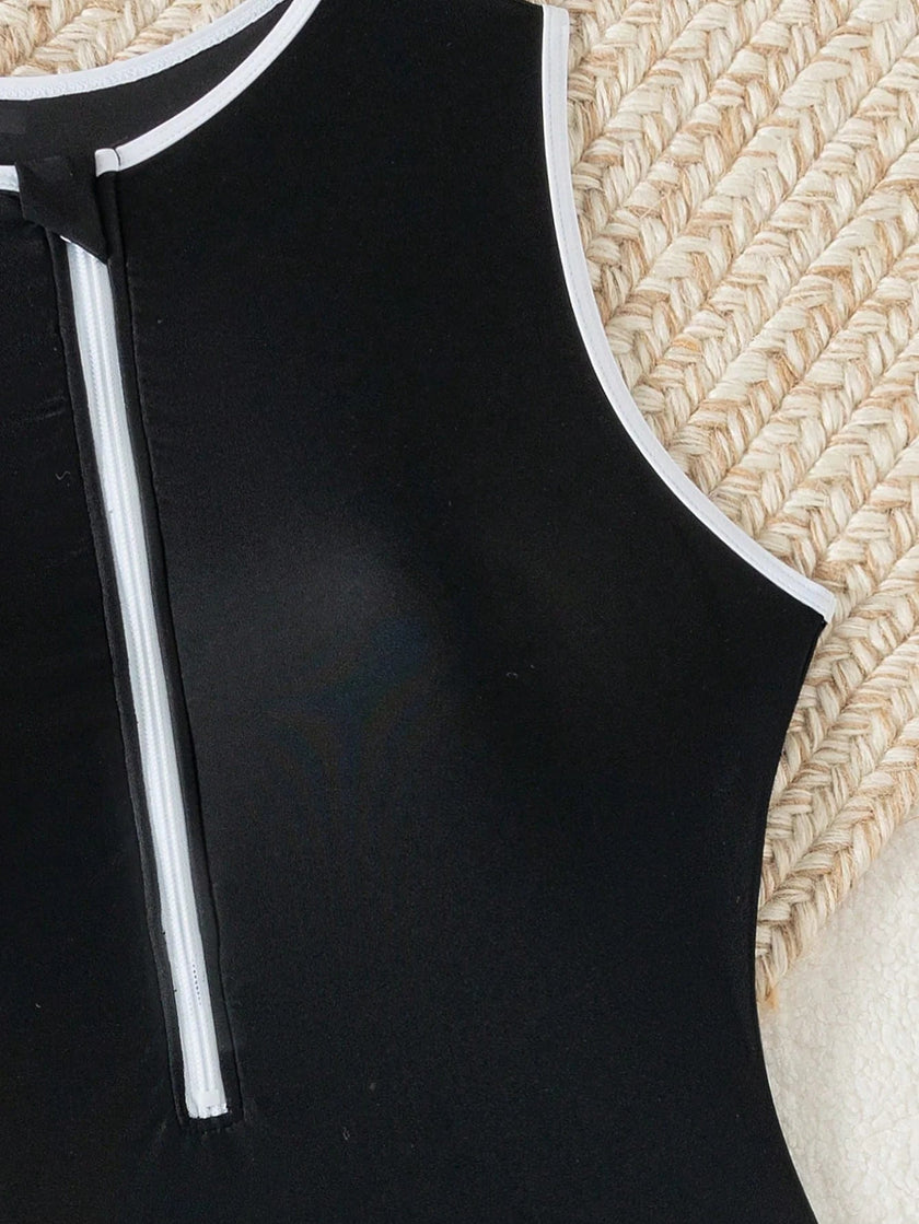 Women's FJØRNA sporty high neck zip swimsuit, elegant and functional swimwear with a high neckline and zipper detail.