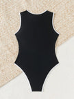 FJØRNA women's sporty high neck zip swimsuit in black, featuring a high neckline and sleek design for active beachwear.