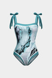 Women's abstract print swimsuit set with pareo from FJØRNA, featuring stylish strappy details and vibrant design.
