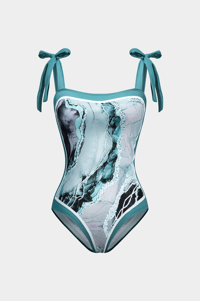 Women's abstract print swimsuit set with pareo from FJØRNA, featuring stylish strappy details and vibrant design.