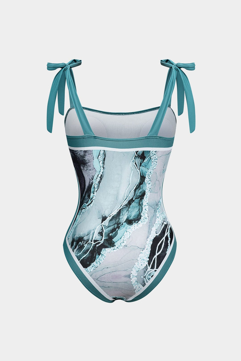 Women's abstract print swimsuit set with pareo by FJØRNA, featuring strappy details and stylish design for swimwear fashion.
