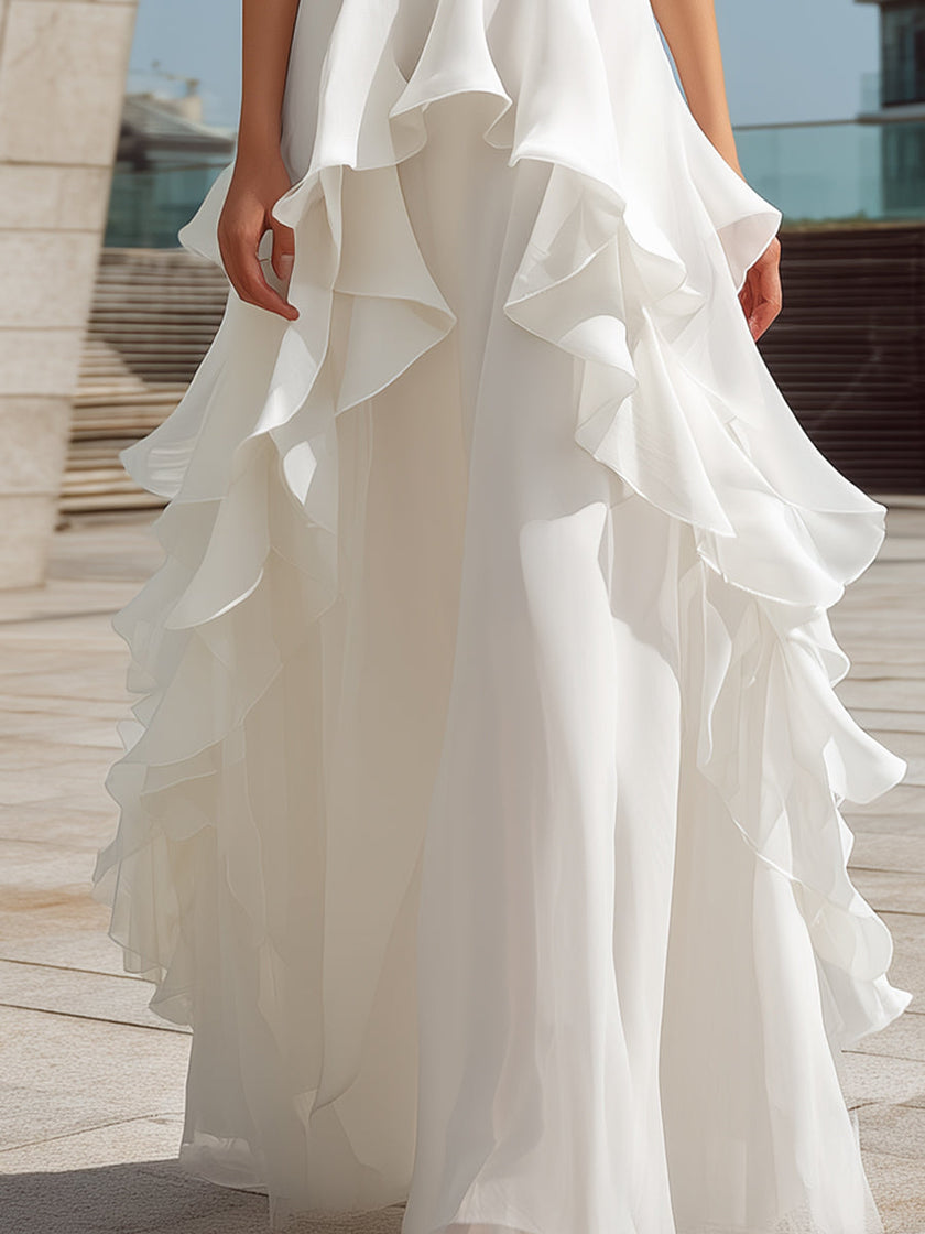 White halter layered ruffle maxi dress by FJØRNA, featuring flowing fabric and tiered ruffles perfect for summer occasions.