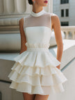 FJØRNA high-neck sheer yoke tiered ruffle mini dress with layered ruffles and delicate fabric details.