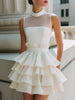 FJØRNA high-neck sheer yoke tiered ruffle mini dress with layered ruffles and delicate fabric details.