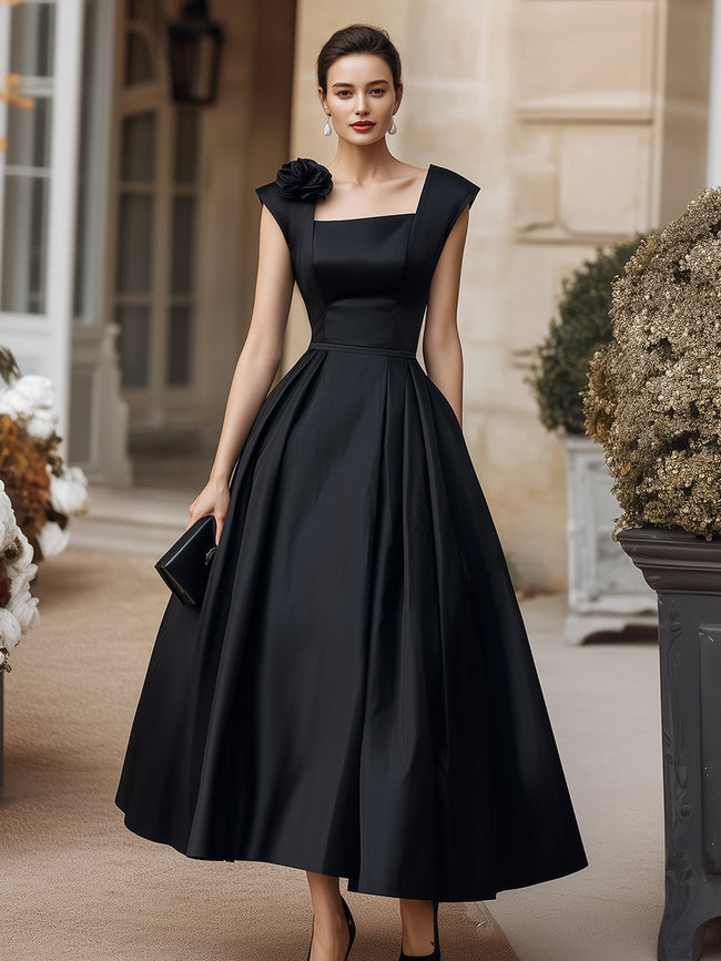 FJØRNA square neck structured midi dress with floral shoulder accents, showcasing a fitted silhouette and elegant design.
