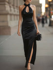 FJØRNA black satin halter neck gown with slit, elegant maxi dress featuring a fitted bodice and flowing skirt.