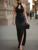 FJØRNA black satin halter neck gown with slit, elegant maxi dress featuring a fitted bodice and flowing skirt.