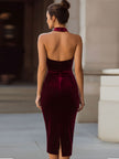 FJØRNA rich burgundy velvet halter-neck bodycon midi dress, form-fitting with a sleek design and elegant midi length.