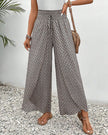Beige lightweight summer trousers for women by FJØRNA, wide-leg flowy and breathable for comfortable warm-weather wear.