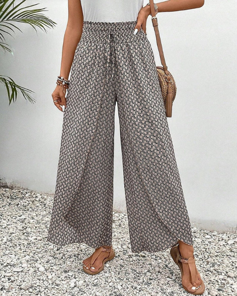 Beige lightweight summer trousers for women by FJØRNA, wide-leg flowy and breathable for comfortable warm-weather wear.