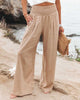 Beige lightweight summer trousers for women by FJØRNA, wide-leg flowy and breathable for a comfortable summer look.