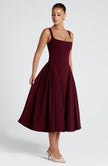 FJØRNA Betty Midi Dress in cherry lacquer finish, elegant white midi dress with a sleek, fitted silhouette and stylish design.