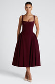 FJØRNA Betty Cherry Laca Midi Dress in white, elegant midi-length dress with glossy cherry-red finish, perfect for stylish occasions.