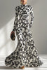 Black and white color-blocked printed long-sleeve maxi dress by FJØRNA with pleated skirt and front pockets in a slim-fit design.