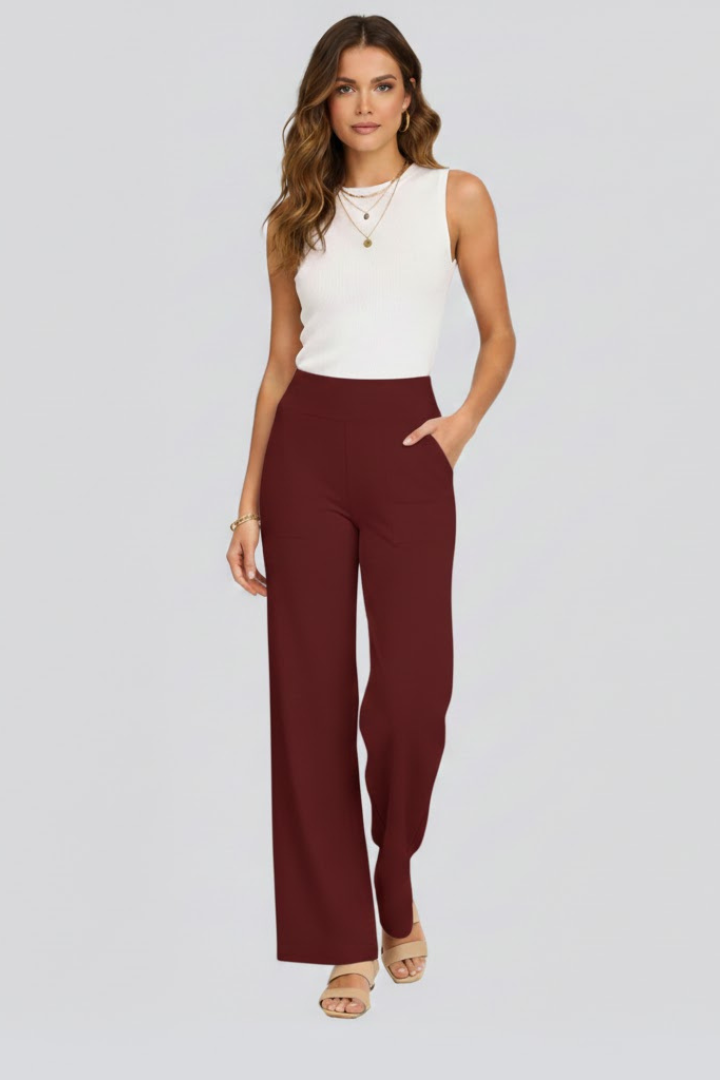 FJØRNA Bianca women's high-rise wide-leg trousers, stylish pants with a relaxed fit and tailored waistband, shown on a model.