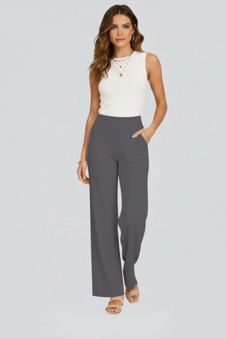 FJØRNA Bianca women's high-rise wide-leg trousers shown in beige fabric, full-length with a relaxed fit and tailored waistband.