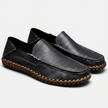 Men's handstitched PU leather slip-on loafers by FJØRNA with round toe, perfect for smart casual style, shown in a natural pose.