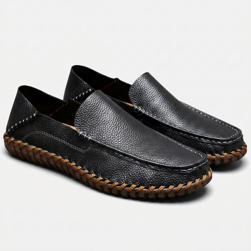 Men's handstitched PU leather slip-on loafers by FJØRNA with round toe, perfect for smart casual style, shown in a natural pose.
