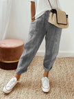 FJØRNA Holly™ striped black pants with a relaxed fit, featuring a high waist and bold horizontal stripe pattern.