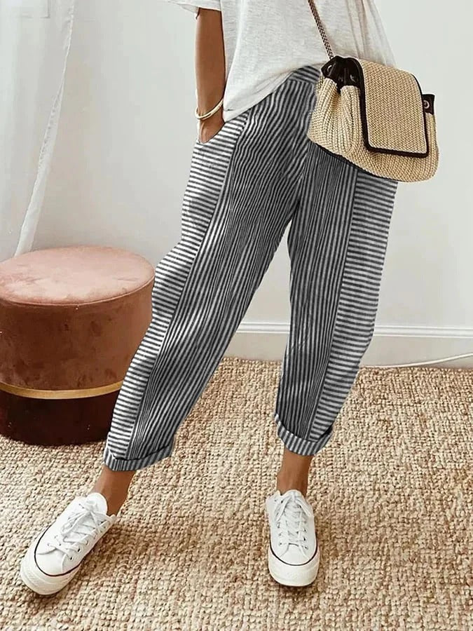 FJØRNA Holly™ striped black pants with a relaxed fit, featuring a high waist and bold horizontal stripe pattern.