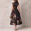 Back view of FJØRNA black floral midi dress with Mao neckline and keyhole detail, stylish and elegant for casual or formal wear.