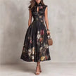 FJØRNA black floral midi dress with Mao collar and keyhole neckline, featuring long sleeves and a fitted silhouette.