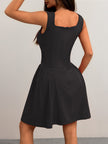FJØRNA black flared fit mini dress with square neckline, back view, perfect for summer in a stylish black tailored design.