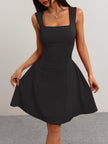 Black flared fit summer dress by FJØRNA with square neckline, front view, tailored mini dress in black and red.