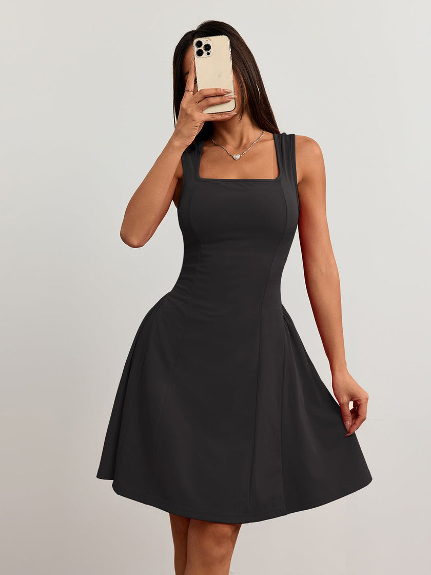FJØRNA black square-neck mini dress with flared fit, featuring red and black summer design, shown as a selfie image.