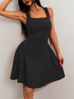 FJØRNA black flared fit mini dress with square neckline, tailored design, ideal for summer occasions.